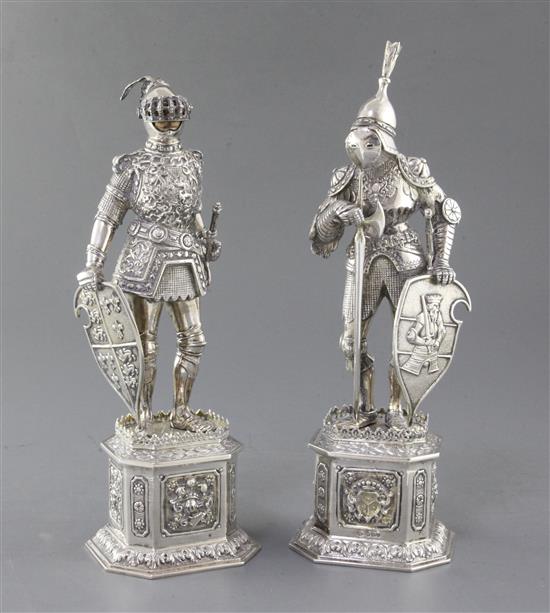 A pair of early 20th century German parcel gilt silver & card ivory figures, modelled as Knights, gross 47 oz.